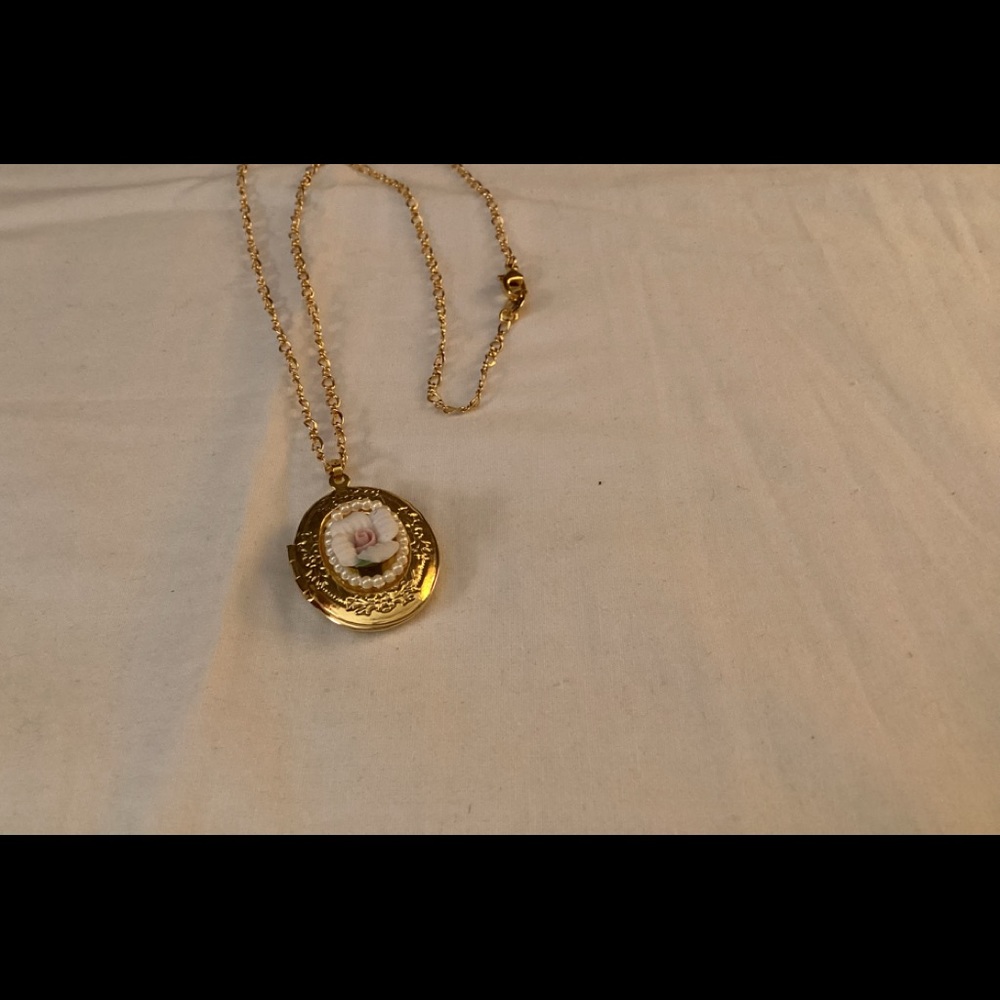 Vintage style gold tone locket with raised rose  flower.